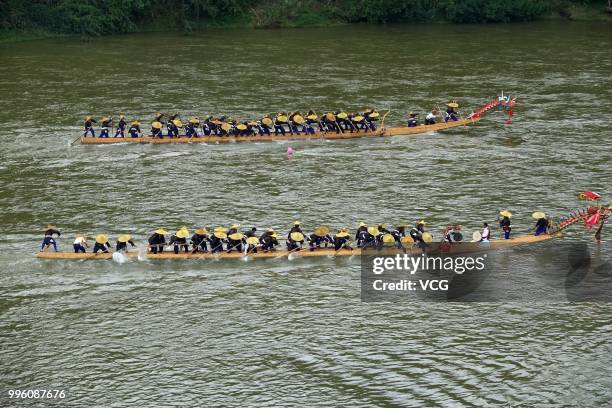 People of Miao Ethnic Group of Taijiang County compete in a dragon boat race on Qingshui River to celebrate the Dragon Canoe Festival at Shidong Town...