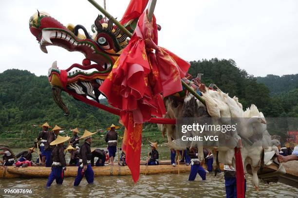 People of Miao Ethnic Group of Taijiang County compete in a dragon boat race on Qingshui River to celebrate the Dragon Canoe Festival at Shidong Town...