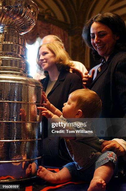 Reagan Feld, 7 months, checks out the Stanley Cup during a reception the Cup and the owners of the Detroit Red Wings, while mom Melissa Feld from the...