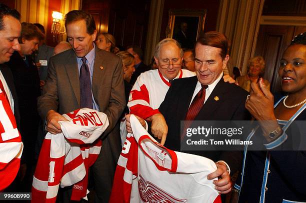 Sen. Carl Levin, D-Mich., and Rep. Dale Kildee, D-Mich., check out their new Red Wings Jerseys during a reception for the Stanley Cup and the owners...