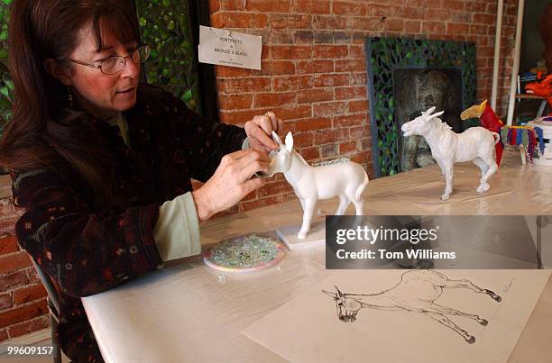 Capitol Hill artist Kris Swanson makes a glass mosiac on minature model of a donkey as part of a project by the DC Commision on the Arts and...