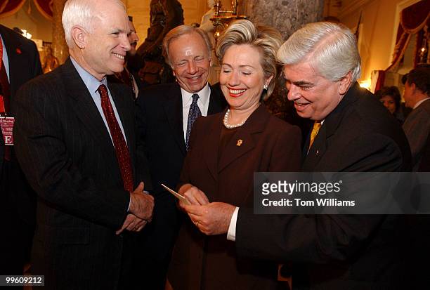 Sens. From left, John McCain, R-Ariz., Joe Lieberman, D-Conn., Hillary Clinton, D-N.Y., and Chris Dodd, D-Conn., check out a picture of a...