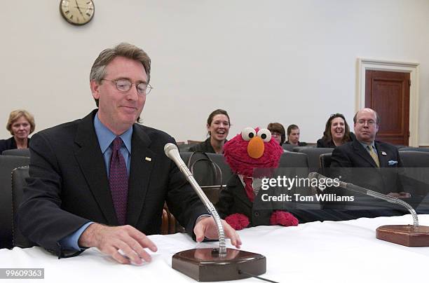 Rep. Randy "Duke" Cunningham, R-Calif., poses with Elmo, from "Sesame Street", during the furry monster's first appearence on Captiol Hill before the...