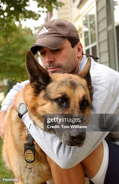 Capitol Police Dog, Fanto, is embraced by his handler Techinician Shawn Haynes in their Waldorf, Md. Home. The 11 year old German Shepard was forced...