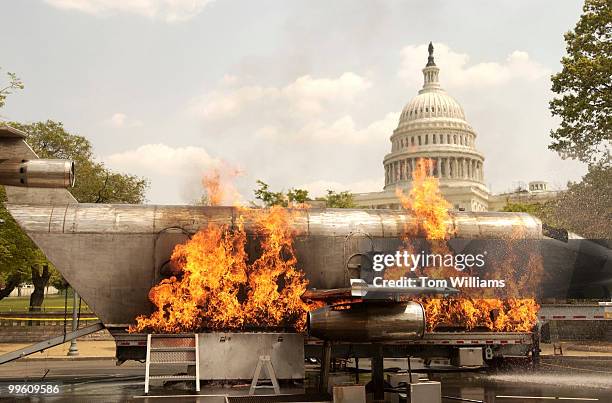 Foot aircraft simulator is set ablaze before firefighters extingiush it on Garfield Circle, Capitol Hill. The 14th Annual National Fire and Emergency...