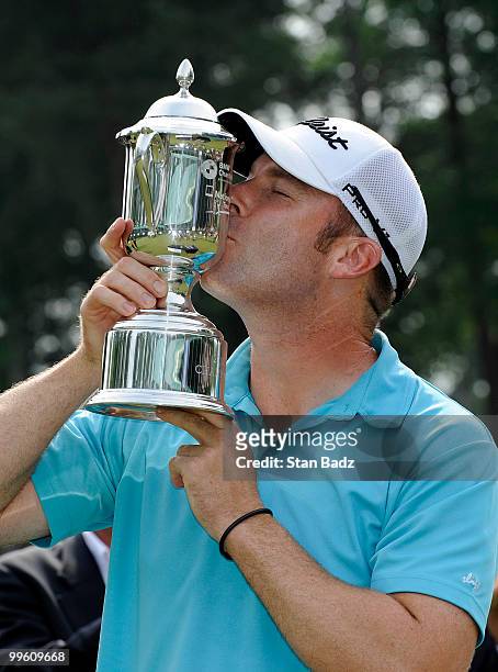 Justin Hicks kisses the winner's trophy after the final round of the BMW Charity Pro-Am presented by SYNNEX Corporation at the Thornblade Club on May...