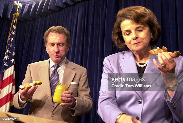 Sen. Arlen Specter, R-PA, presents pretzels and mustard from Philadelphia to Sen. Diane Feinstein, D-CA, as a result of a lost bet on the NBA Finals...