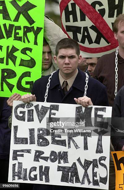Jason Talley, a member of Taxslaverysucks.org, listens to speakers at the "Tax Freedom Day" rally on the East Frnt Lawn. Members of various...