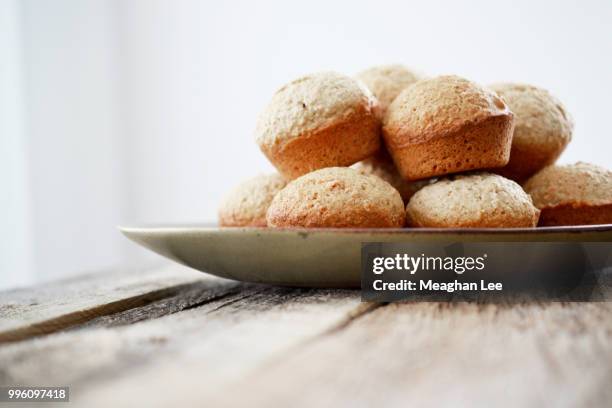 muffins on plate at rustic table - longan stock-fotos und bilder