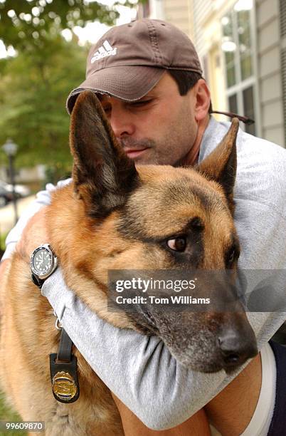 Capitol Police Dog, Fanto, is embraced by his handler Techinician Shawn Haynes in their Waldorf, Md. Home. The 11 year old German Shepard was forced...