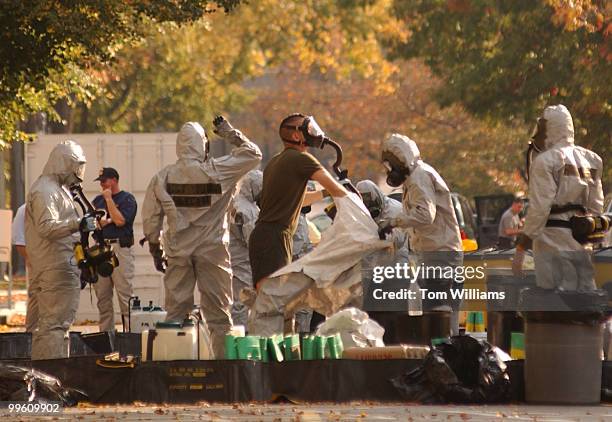 Workers in Hazardous Material suits regroup on South Capitol St. After sweeping House Office Buildings for anthrax.