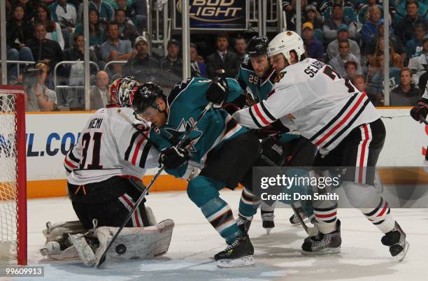 Antti Niemi and Brent Seabrook of the Chicago Blackhawks defend the net against Joe Pavelski and Ryane Clowe of the San Jose Sharks in Game One of...