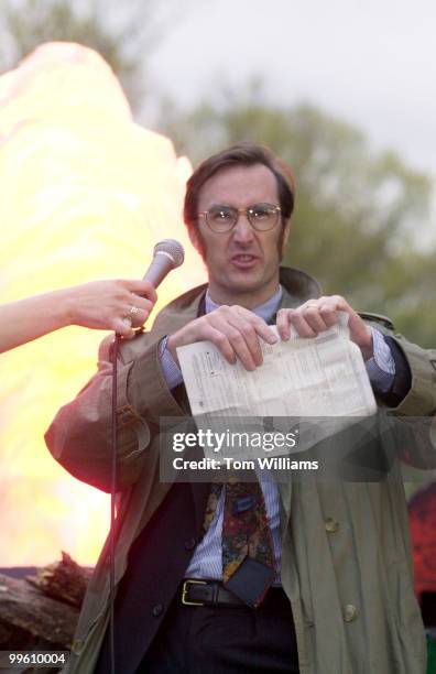 John Welsh of Cleveland Park prepares to tear up a tax form at the "Bonfire of the 1040's" Tax Day Demonstration, in which DC tax payers protested...