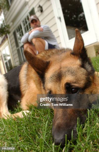Capitol Police Dog, Fanto, rests with his handler Techinician Shawn Haynes in their Waldorf, Md. Home. The 11 year old German Shepard was forced into...