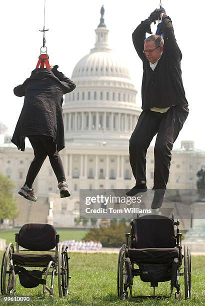Eric Muhlrad, left, and Martin Kace, both paraplegics, stage a mock hanging on the West Front Reflecting Pool, to dramatize to Senators the...