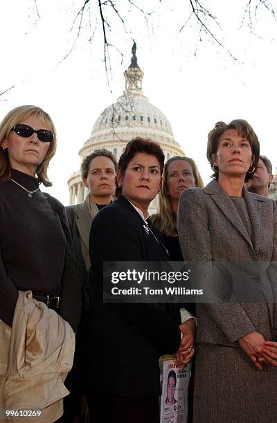 Nilsa Isaias, center, and Ginnie Bauer, at right, husbands both died at the World Trade Center gahter with widows of the September 11th attacks to...