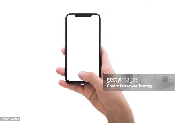 close up hand hold phone isolated on white - hand stock-fotos und bilder