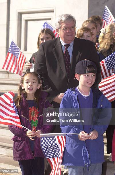 Nine year old Andrew Schwartz, pumps his fist in agreement with speaker J.C. Watts, R-OK, at a press conference in which House Republicans pointed...