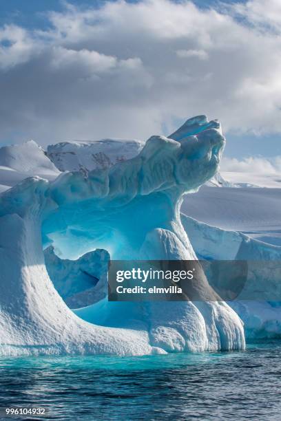 weather eroded iceberg in wilhemina bay antarctica - polar stock pictures, royalty-free photos & images