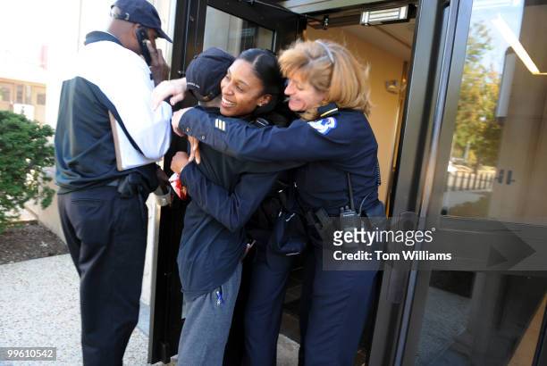 Capitol Police officers La-Toya Daniels and Pamela Jordan, right, greet Aidan Sims of the U.S. Capitol Police, outside of headquarters on the day he...