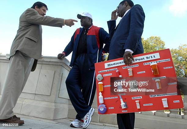 Marvin Bethea, right, a paramedic at on 9-11-01, holds a board displaying the 13 medications he must take daily due to his exposure at ground zero....