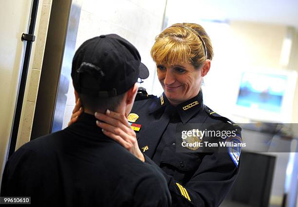 Off. Pamela Jordan of the U.S. Capitol Police says goodbye to fellow officer Aidan Sims after he visited headquarters on the day he was released from...