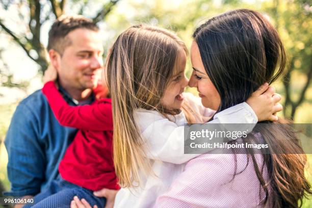 happy family with two small children outside in spring nature, hugging. - halfpoint stockfoto's en -beelden