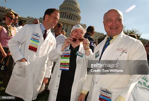 Emergency medical physicians, from left, James Williams, Diane Fite, and David Wilcox, attend a rally held by the American College of Emergency...