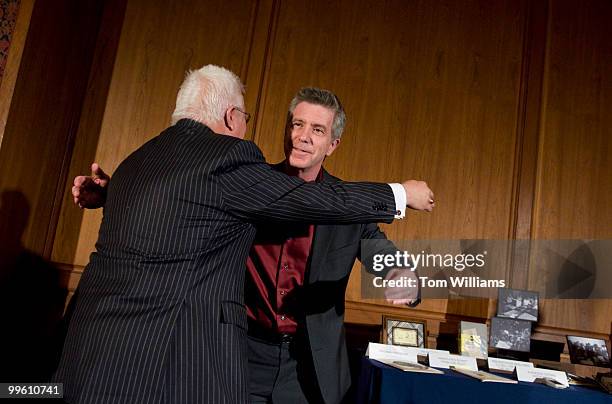 Host of America's Funniest Home Videos Tom Bergeron, right, hugs Vin Di Bono, creator and executive producer, during a ceremony to donate objects...