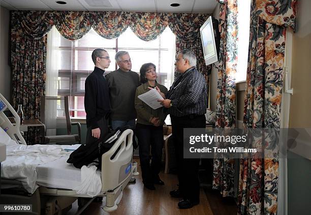 Dr. John Aseff goes over release papers with Aidan Sims of the U.S. Capitol Police, his father David, and his mother Gretel Lauro, at the National...