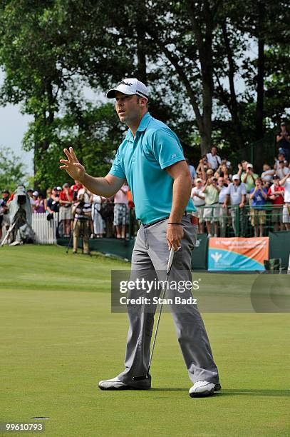 Justin Hicks waves to the gallery on the 18th green after winning the BMW Charity Pro-Am presented by SYNNEX Corporation at the Thornblade Club on...