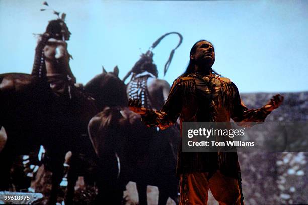 Steven Alvarez of Anchorage, Alaska, performs a song with a multimedia display at the National Museum of the American Indian. The theme of the...