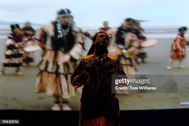 Steven Alvarez of Anchorage, Alaska, performs a song with a multimedia display at the National Museum of the American Indian. The theme of the...