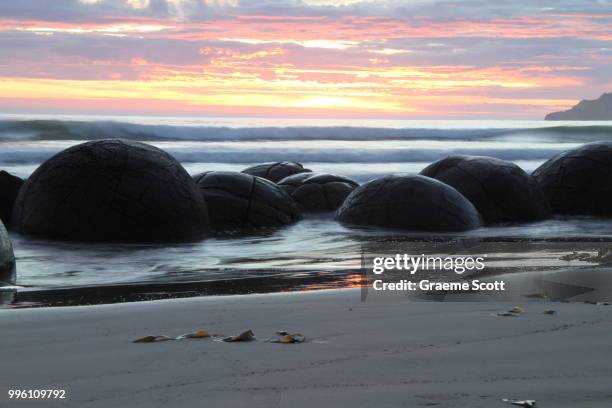 moeraki boulders at dawn - moeraki stock pictures, royalty-free photos & images