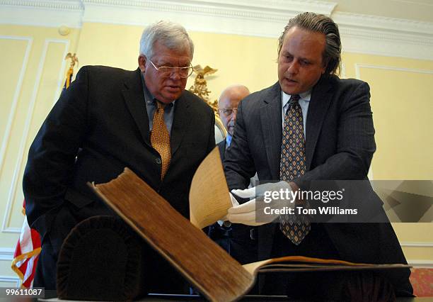 Richard Hunt, director of the Center for Legislative Archives, right, shows the original, handwritten Journal of the U.S. House of Representatives...