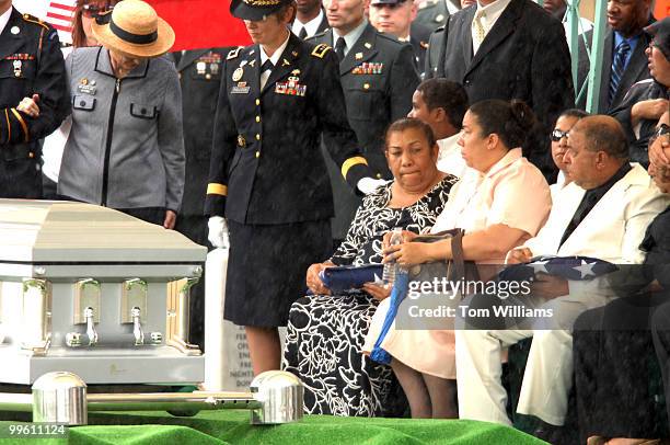 Iris Santiago holds the American flag that was draped over the casket of her daughter, Army Captain Maria Ines Ortiz, the first Army nurse to killed...