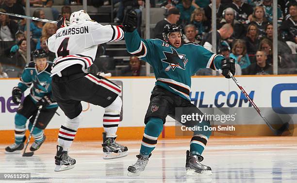 Niklas Hjalmarsson of the Chicago Blackhawks collides with Devin Setoguchi of the San Jose Sharks in Game One of the Western Conference Finals during...