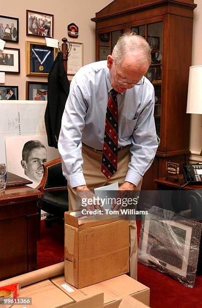 Rep. Cass Ballenger, R-N.C., packs up pictures in his office before his retirement. Ballenger served 9 terms in Congress.