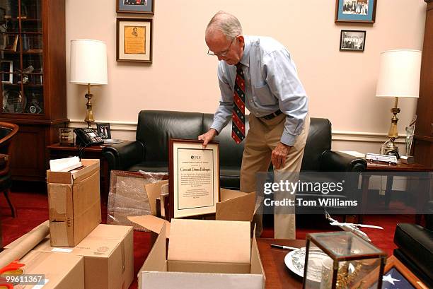 Rep. Cass Ballenger, R-N.C., packs up pictures in his office before his retirement. Ballenger served 9 terms in Congress.