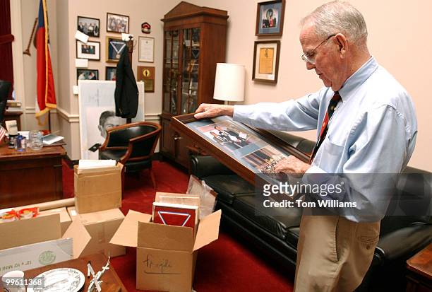 Rep. Cass Ballenger, R-N.C., packs up pictures in his office before his retirement. Ballenger served 9 terms in Congress.