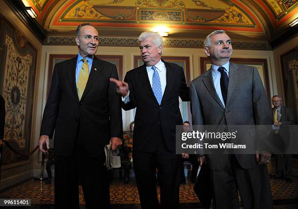 From left, Sen. Charles Schumer, D-N.Y., Senate Banking Committee Chairman Chris Dodd, D-Conn., and Sen. Jack Reed, R-R.I., walk to a meeting on the...