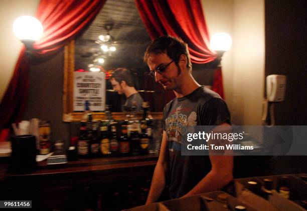 Matt Brown, manager of The Red and the Black on H Street, NE, readies the upstairs bar where musical performances are held.