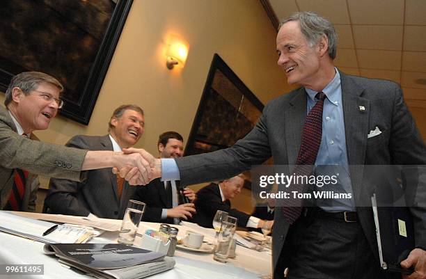 Mort Kondracke, left, Roll Call, shakes hands with Sen. Tom Carper, D-Del., at a breakfast at Johnny's Half Shell, to talk about global warming....