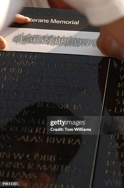 An engraver makes a rubbing of Capt. Edward Alan Brudno, USAF, at in the Vietnam Veterans Memorial, Monday, after his name was added to the Wall....