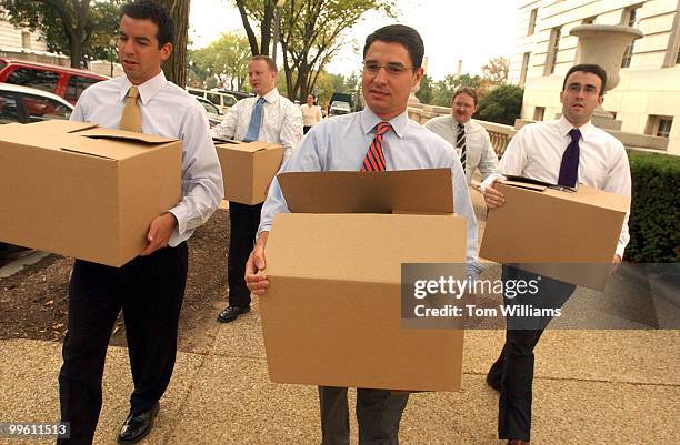 From left, Matt Dennis, Chris Hartmann, Chris Gaston, and Seth Tillman, from the office of Rep. Rush Holt, D-N.J., bring boxes of donated goods to be...