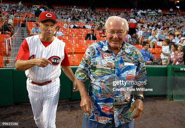 Coach of the Republican team Mike Oxley, R-Ohio, left, and former House Minority Leader Bob Michel, R-Ill., take the field for the first pitch at the...