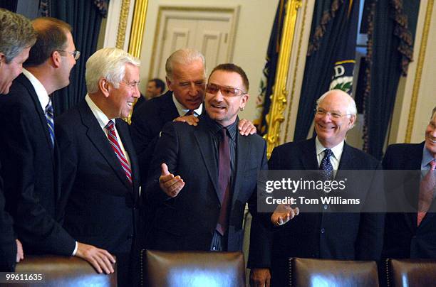 Musician Bono, gets a word from Sen. Joe Biden, D-Del., before a meeting of the Senate Foreign Relations Committee they discussed African debt...