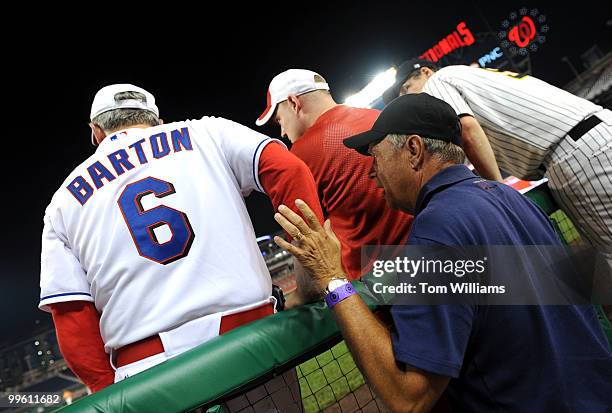 Former Republican Coach Mike Oxley, D-Ohio, right, gives advice to current coach Joe Barton, R-Texas, during the annual Congressional Baseball, won...