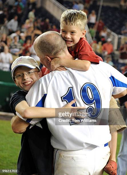 Rep. Kevin Brady, R-Texas, carries his children Sean and Will after the annual Congressional Baseball, won by the Republicans, July 17, 2008.