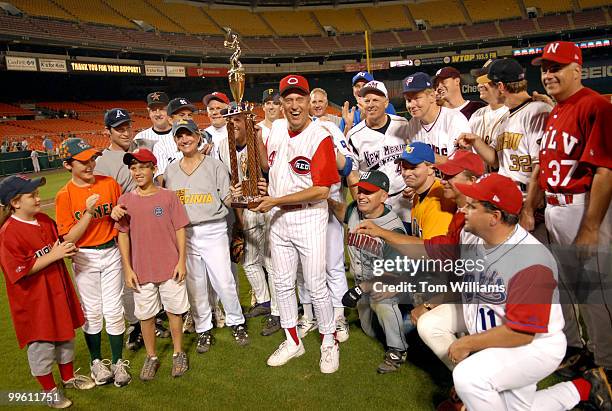 Coach Mike Oxley, R-Ohio, with trophy, celebrates with the republican team after the 45th Annual Roll Call Congressional Baseball game played at RFK...